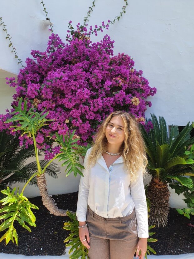 Intern in front of the hibiscus plant