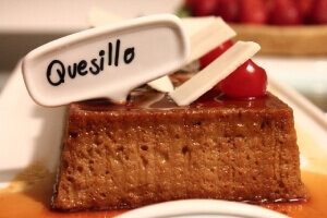 A hotel intern enjoying a serving of quesillo canario, a traditional Canarian dessert, after their internship.